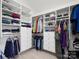 Walk-in closet with custom shelving, drawers, and hanging rods at 3100 Stanway Ct, Waxhaw, NC 28173