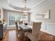 Inviting dining room featuring tray ceilings and natural light from a large window at 3100 Stanway Ct, Waxhaw, NC 28173