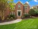 Charming brick home featuring a well-maintained lawn and inviting front entrance at 3100 Stanway Ct, Waxhaw, NC 28173