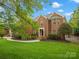 Beautiful brick home with a well-manicured lawn and lush landscaping at 3100 Stanway Ct, Waxhaw, NC 28173