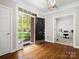 Welcoming foyer with gleaming hardwood floors and view of the home office at 3100 Stanway Ct, Waxhaw, NC 28173