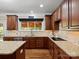 Classic kitchen boasting granite counters, dark wood cabinets, tile backsplash and stainless steel appliances at 3100 Stanway Ct, Waxhaw, NC 28173