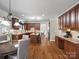 A kitchen with wooden cabinets, granite countertops, breakfast nook, and open access to other rooms at 3100 Stanway Ct, Waxhaw, NC 28173