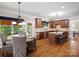 Open-concept kitchen with granite countertops, wooden cabinets, island, and adjacent breakfast nook at 3100 Stanway Ct, Waxhaw, NC 28173
