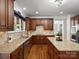 Well-lit kitchen with granite countertops, custom cabinetry, stainless steel appliances, and tile backsplash at 3100 Stanway Ct, Waxhaw, NC 28173