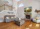Cozy living room featuring a stone fireplace and hardwood floors at 3100 Stanway Ct, Waxhaw, NC 28173