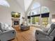 Bright living room with large arched windows, stone fireplace and comfortable seating at 3100 Stanway Ct, Waxhaw, NC 28173