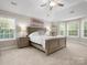 Spacious main bedroom featuring tray ceiling, carpet, and lots of natural light at 3100 Stanway Ct, Waxhaw, NC 28173