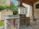 Outdoor kitchen with stainless steel grill, stone accents, and ample counter space for alfresco dining and entertaining at 3100 Stanway Ct, Waxhaw, NC 28173