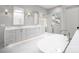 A spacious bathroom boasts a freestanding tub, double vanities, skylight, and a large window for natural light at 3212 Willow Oak Rd, Charlotte, NC 28209