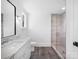 Bathroom featuring a marble vanity, black framed mirror, and walk-in shower at 3212 Willow Oak Rd, Charlotte, NC 28209