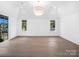 A spacious bedroom features hardwood floors, neutral paint, two windows, and recessed lighting at 3212 Willow Oak Rd, Charlotte, NC 28209