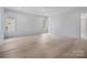 Spacious bedroom with light wood floors, white walls, and large windows that provide ample natural light at 3212 Willow Oak Rd, Charlotte, NC 28209