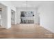 Formal dining room with light wood floors, modern chandelier, and access to the outdoor patio at 3212 Willow Oak Rd, Charlotte, NC 28209