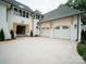 Wide driveway leading to a stunning new construction home with a two-car garage and a modern design at 3212 Willow Oak Rd, Charlotte, NC 28209
