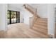 Bright entryway with light wood floors, staircase, and large windows that provide plenty of natural light at 3212 Willow Oak Rd, Charlotte, NC 28209