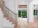 Bright entryway featuring light wood floors and staircase leading to other parts of the home at 3212 Willow Oak Rd, Charlotte, NC 28209