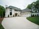 Expansive new construction home with white brick, a two-car garage, and a modern, inviting design with manicured lawn at 3212 Willow Oak Rd, Charlotte, NC 28209