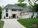 Stunning white home with a manicured lawn, elegant black windows, and a charming three-car garage at 3212 Willow Oak Rd, Charlotte, NC 28209