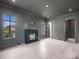 Living room featuring a dark fireplace with hearth, light wood floors, and views to the exterior at 3212 Willow Oak Rd, Charlotte, NC 28209