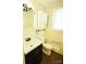 Bathroom featuring a white sink, toilet, and a white cabinet at 3238 Pinehurst Pl # B, Charlotte, NC 28209