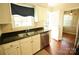 Well-lit kitchen featuring stainless steel appliances, granite counters, and a double sink at 3238 Pinehurst Pl # B, Charlotte, NC 28209