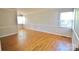 Bright, airy living room with gleaming hardwood floors and neutral paint, perfect for entertaining and relaxing at 3238 Pinehurst Pl # B, Charlotte, NC 28209