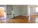 Spacious living room showcasing hardwood floors, decorative molding, and an inviting entrance foyer at 3238 Pinehurst Pl # B, Charlotte, NC 28209