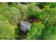 Aerial view of the home surrounded by lush greenery, trees, and landscaping at 3412 Country Club Dr, Gastonia, NC 28056