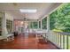 A large screened back porch with rocking chairs and a table at 3412 Country Club Dr, Gastonia, NC 28056
