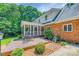 Relaxing deck is set among trees and greenery; adjacent to a classic brick exterior at 3412 Country Club Dr, Gastonia, NC 28056