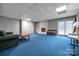 Spacious finished basement with gray walls, cozy fireplace, and convenient walkout access at 3412 Country Club Dr, Gastonia, NC 28056