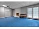 Finished basement featuring a cozy brick fireplace, painted white, and walkout access at 3412 Country Club Dr, Gastonia, NC 28056