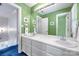 Bathroom with a dual-sink vanity and bright green walls at 3412 Country Club Dr, Gastonia, NC 28056