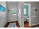 Hallway view of a bathroom with a white vanity, modern toilet, and interior decor at 3412 Country Club Dr, Gastonia, NC 28056