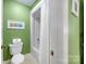 Bright bathroom with a shower-tub combo and green painted walls at 3412 Country Club Dr, Gastonia, NC 28056