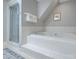 Bathroom with a tub and shower featuring blue and white stripped wallpaper at 3412 Country Club Dr, Gastonia, NC 28056
