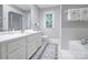 Bright bathroom with a tub, shower, and white vanity at 3412 Country Club Dr, Gastonia, NC 28056