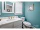 Bathroom with white vanity, stylish fixtures, and a modern toilet at 3412 Country Club Dr, Gastonia, NC 28056