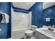Full bathroom featuring a shower-tub combo with classic fixtures and stylish blue textured walls at 3412 Country Club Dr, Gastonia, NC 28056