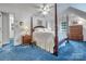 Bedroom featuring a four-poster bed, ceiling fan and blue carpet at 3412 Country Club Dr, Gastonia, NC 28056