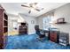 Well-lit bedroom with ceiling fan, desk, and ample storage cabinets at 3412 Country Club Dr, Gastonia, NC 28056