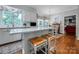 Eat-in kitchen features a quartz top island with seating with an adjacent dining area near window views at 3412 Country Club Dr, Gastonia, NC 28056