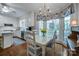 Cozy dining area with bright windows, stylish chandelier, and a kitchen view at 3412 Country Club Dr, Gastonia, NC 28056