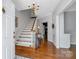 Elegant foyer with hardwood floors, staircase, chandelier and neutral wall paint color at 3412 Country Club Dr, Gastonia, NC 28056