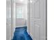 Hallway featuring blue carpet and multiple white doors at 3412 Country Club Dr, Gastonia, NC 28056