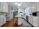 Bright kitchen with white cabinetry, stainless steel appliances, and a center island with seating at 3412 Country Club Dr, Gastonia, NC 28056