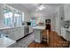 Open kitchen with white cabinetry, stainless steel appliances, an island, and hardwood floors at 3412 Country Club Dr, Gastonia, NC 28056