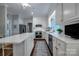 Spacious white kitchen featuring stainless appliances, a center island, and hardwood floors at 3412 Country Club Dr, Gastonia, NC 28056