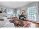 Living room featuring a piano, hardwood floors, natural light, and soft neutral wall paint at 3412 Country Club Dr, Gastonia, NC 28056